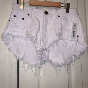 Editorial white distressed jean shorts